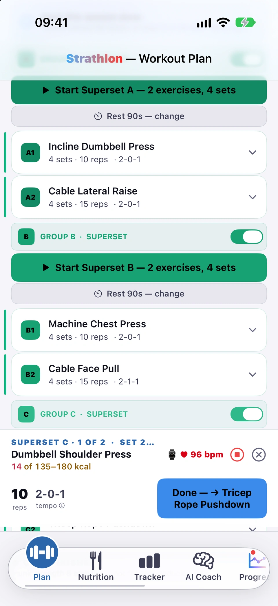 The Plan tab mid-session with the live panel at the bottom: Superset C, 1 of 2, set 2, Dumbbell Shoulder Press, a line under the exercise name showing the burn your watch has recorded so far against the session's estimated range, 10 reps at tempo 2-0-1, the watch's 96 bpm, the stop and close buttons, and Done → Tricep Rope Pushdown.