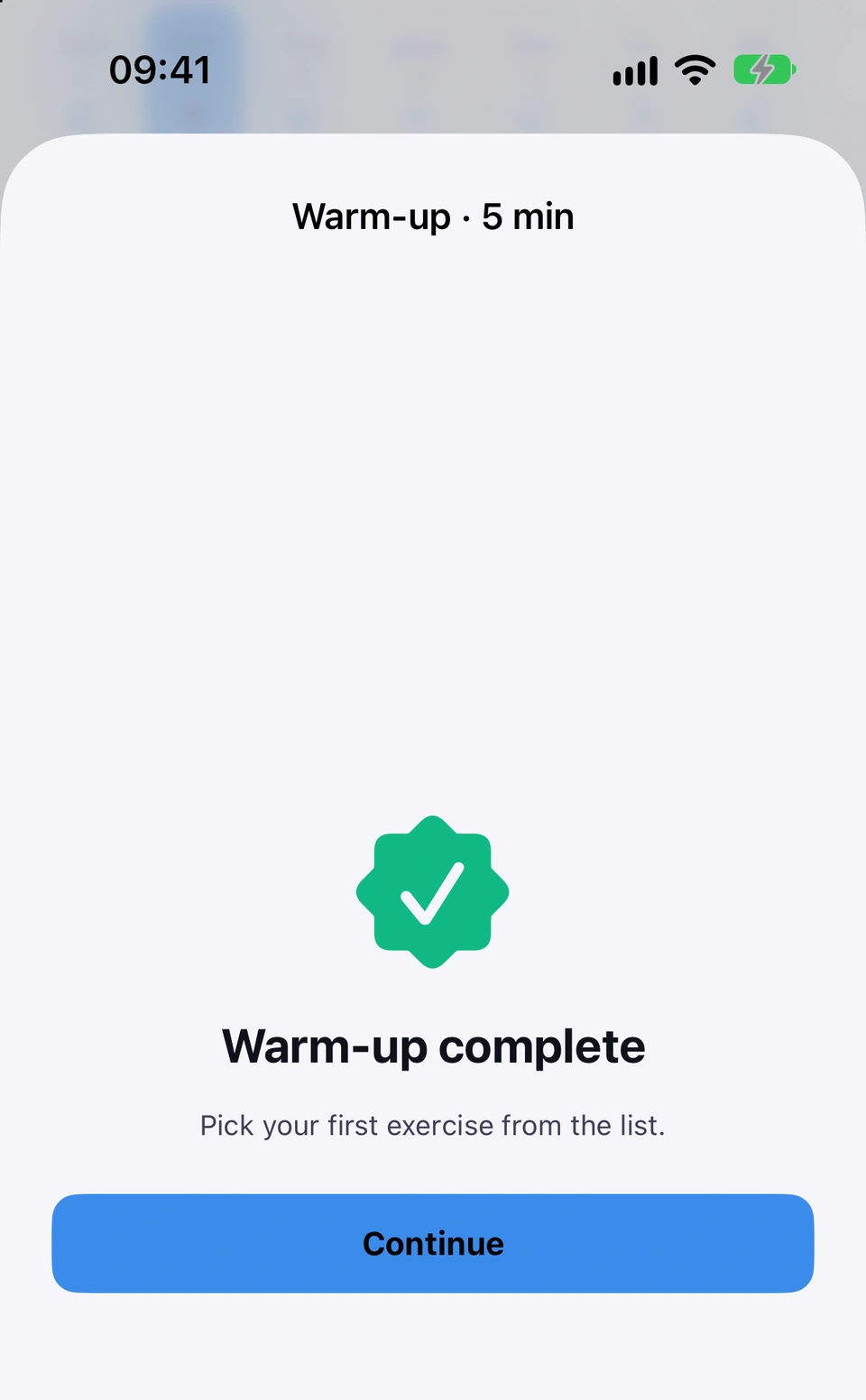 Warm-up complete, with a green tick, the line Pick your first exercise from the list, and a Continue button.
