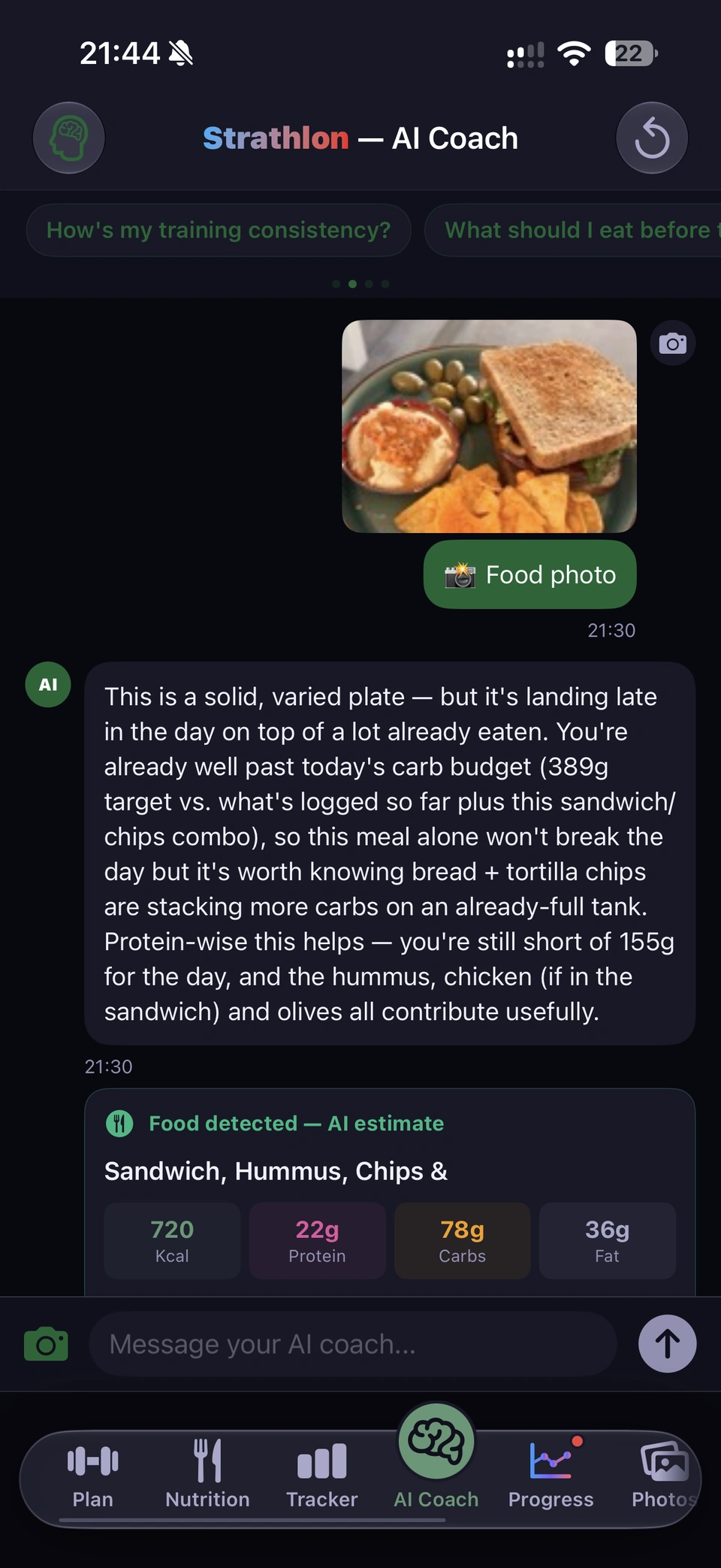 Strathlon AI Coach, one chat scrolled from top to bottom: a photo of a plate with a toasted sandwich, hummus, olives and tortilla chips, sent as a food photo; the coach's reply that the plate lands late on top of a lot already eaten, the day is past its carb target and still short of its 155 g protein target; then the Food detected, AI estimate card: Sandwich, Hummus, Chips, 720 kcal, 22 g protein, 78 g carbs, 36 g fat, with its four items, and the buttons Replace the logged meal, Add as a separate entry, I didn't finish this, and Save as regular meal.